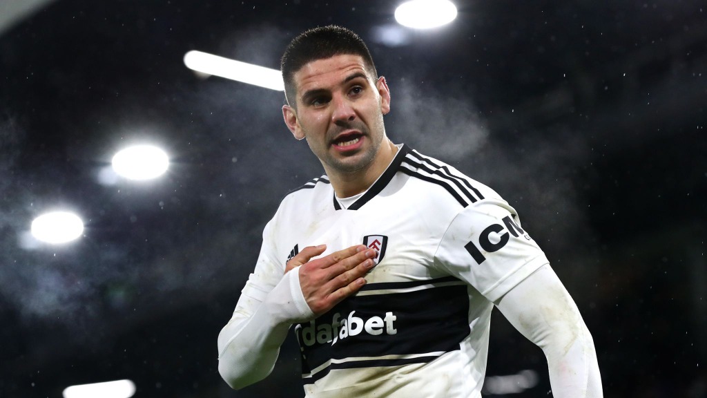 Aleksandar Mitrović in Fulham shirt celebrating goal with hand on his heart